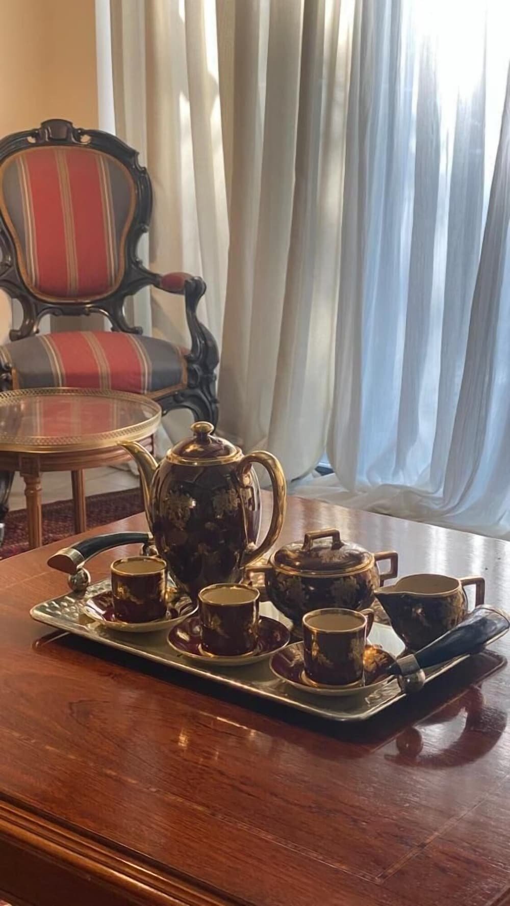 Mesa de madera con bandeja, tetera, tazas y azucarera