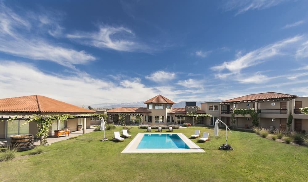 Área da piscina com espreguiçadeiras sob céu limpo